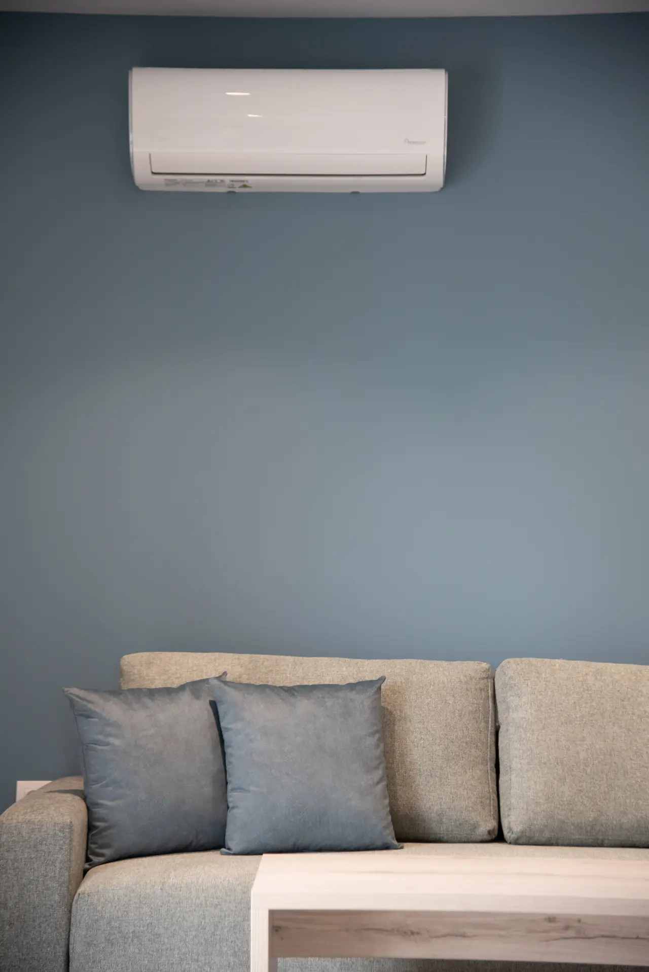 Sofa with cushions under the air conditioner